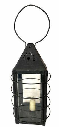 G769 Tin lantern with decorative cut out vents at top of stars, four glass sides with four rounded wires around body to protect fingers/hands from hot glass. Sliding metal with glass door on back raises for access to inside. with candle holder inside 