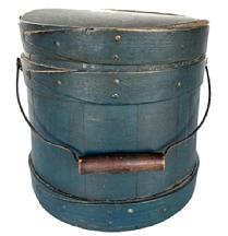 **SOLD** RM1491 Fantastic 19th century Pennsylvania small sized lidded Firkin bearing the most beautiful original dark blue painted surface.  Tongue and groove softwood staved sides are held in place with tapered lap joint wood bands that are secured with copper tacks � and one small staple at the very end of each point of the band�s overlap. Wire bail swing handle with wooden handle grip. Clean, natural patina interior. Measurements: 7 ¾� diameter (top) x 8 ¼� diameter (bottom) x 7 ¾� tall