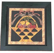 H510 Framed folk art original papercutting German Scherenschnitte signed R. Hinsdale 1991 (Rhonda Hinsdale, renowned folk artist) depicting a basket of fruit with two birds holding a ribbon in their beaks. Measurements: Viewing area measures 7 ½� square. Frame is 9 ½� square.