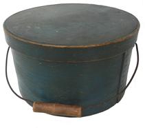 W276 New England Bail Handle Pantry Box with the original blue paint .with over lapping bentwood sides, secured with small metal tacks. The sides of the Box are fitted with a pair of oval stamped tin  handle mounts. Fitted with an arched wire swing handle with wooden hand grips.