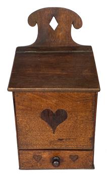 G732 19th century Pennsylvania wall box with three hand carved and inlaid hearts on the front. This beautiful wall box features a dovetailed drawer, canted lift lid, interesting cutout on back, diamond shaped hole for hanging and three inlaid hearts on the front. Walnut wood. Square head nail construction. Measurements: 17 1/4� tall in back, 10 1/2� tall in front. 9� wide x 6 3/4� deep. Each of the two hearts on the drawer are 1� x 1� and the one on the middle of the front measures 3� x 3�.