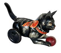 **SOLD** K1803A Early 1930s tin, lithographed, lever action Kitty Kat cat with ball bearing manufacturers mark for Marx Toys  Made in United States of America  New York, NY When this kittys lever tail is pushed down, kitty travels forward chasing its red wooden ball. The lever mechanism is in working order.