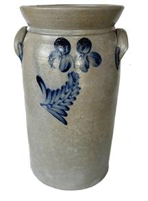 H402 Butter Churn Crock with beautiful cobalt clover and leaf decorations attributed to Peter Hermann of Baltimore, Maryland. Tall, cylindrical form with flat bottom, tooled shoulder, flared rim, and applied lug handles with cobalt accents. Inscribed �3� is visible beside handle, just below the rim, on one side. Crack across bottom.  Measurements: 17� tall x 8 ¾� top diameter.