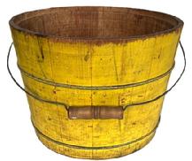 K1856 Late 19th century original vibrant chrome yellow painted bucket from Pennsylvania with arched wire bail handle and turned wooden grip. The interior is old natural patina. Tongue and grooved staved construction held in place with thick wire bands. A childs penciled drawings adorn one side   Measurements:  13 ¼ top diameter x 11 ¼ bottom diameter x 9 ½ tall.  