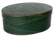 G691 Mid 19th century oval single finger-lapped pantry box in original green paint. Box bears the carved initials �V R� on its top, and prominent brush strokes are visible in the paint. Steamed and bent sides are attached to the top/bottom with tiny wooden pegs, and the beautiful opposing finger laps are secured with small copper tacks. Great natural patina on bottom and inside. Wear indicative of age and use.  Minor, very early, damage spot on one side of the lid�s lip as seen in photographs, but it does not detract from visual appeal of the box. Sturdy and tight. Measurements: 6 5/8� x 5� x 2 ½� tall