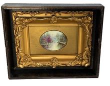 M83 Stunning miniature landscape painting depicting a tranquil stream in a wooded area with soft foliage colors with extremely impressive reflection details. Appears to be hand painted oil on porcelain in a very ornate miniature gold gild frame that is encased in a black painted wooden shadowbox frame. Circa 1880s. Shadowbox measures 9 5/8 wide x 7 ¾ tall x 2 deep. Oval painting area measures 3 wide x 2 ¼ tall.