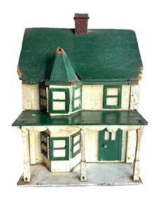 L310 Folk Art Bird House bearing its original green, white and Spanish red painted surface. It has two chimneys and a lot of character with the front bump out with hexagonal roof, overhanging porch with scalloped trim and individual posts, and applied windows and doors. The wood is pine with small wire nail construction.  Early to mid-20th Century.  Measurements are: ~17 &frac14;� deep x ~ 10 &frac14;� wide x ~15� tall.