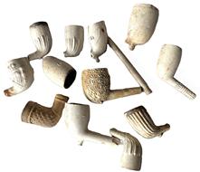 K152A Early - Mid 1800's Group of 12 dug clay pipes  several are embossed / engraved with various slogans (Home Rule), initials (T D), and pictural textures (florals/a harp/ribbing/basket weave/etc.) Grouping is in as found condition. Sizes vary.  