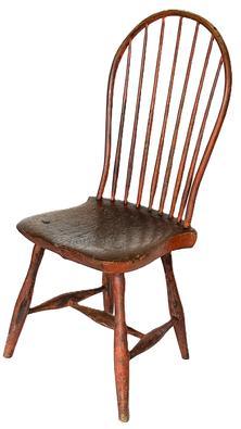 H194A Late 18th to early 19th century Bow-Back Windsor Chair retaining its original bittersweet red painted surface with seven spindle back raised on slightly splayed legs joined by an H-form stretcher. Nice, solid condition with great wear indicative of age. Circa 1790 – 1810. Measurements: 16” deep x 15 ¾” wide x 38 ½” tall (back) x 17” tall (seat front)