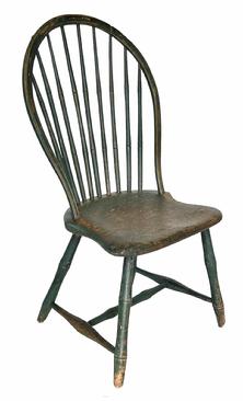 H194 Late 18th century, New England, nine spindle bow back Windsor Chair, shield shaped plank seat, and splayed bamboo-style turned legs, retaining green-painted surface, 18th/early 19th century. Measurements are:  37" high x 18 1/2" wide x 16� deep x 17" seat to floor
