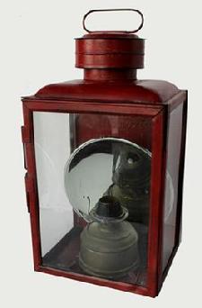 K778) DIETZ NO. 1 "CLIMAX" SHEET IRON STATION / SQUARE RAILROAD LANTERN, in old red paint , and with wire handle, three colorless glass panes including one with a hinged frame, cover marked "DIETZ NO. 1STATION LAMP" and reverse marked "DIETZ / NO. 2 STATION LAMP / NEW YORK U.S.A.", reverse with two mounting holes, interior fitted with a silvered reflector and a removable circular-form font. Fitted with a No. 2 slip burner First quarter 20th century. 17 3/4" H to top of cover, 8 5/8" x 10 1/4".