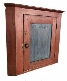 H121 Early 19th century Pennsylvania hanging Corner Cupboard, in the original red and blue paint. This Cupboard has a single panel door which is mortised and pegged, that open to the interior that is also has the original blue paint, it is one board square head nail construction