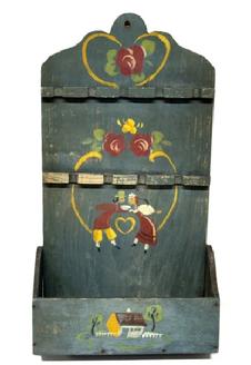 RM1645 Late 19th Century hanging Spoon Rack/ wall Box. One single back board with a cut out design at the top in original blue painted surface with hand painted decorations of Pennsylvania Dutch influence. There are two levels of spoon holders for holding up to a total of nine (9) spoons, over a candle box with shaped sides. The wood is pine with small wire nail construction. Measurements: 9 5/8 wide (back) x 18 ½ tall. The bottom wall box area is 10 ¼ wide x 4 ¼ deep.
