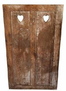 H85 Mid 19th century raised panel Door with hearts cut out, from a wall unit, retains old dark surface on one side and the remnants of white wash on the other side. All mortised & pinned, circa 1850.