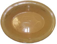 Yellowware baking dish with a deep rim and good color padded feet , marked made in England ion the bottom