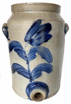 *SOLD* G611 Beautiful stamped Two-Gallon Stoneware Water Cooler with  thick/heavy Cobalt Tulip pattern decoration on both the front and back. Additional cobalt decoration and highlights include dashes below the handles with highlights around the handle edges and highlights around the bunghole. This pattern is attributed to Richard C. Remmey of Philadelphia, Pennsylvania, Circa 1870 - 1880's. The cooler is ovoid with incised lines around the top sections, a stepped bunghole, slightly footed base and applied lug handles.  some chipping to the inside of left handle and around the left side of top rim, but they do not detract from the beauty of this piece. Slight turkey track on back that does not go through to inside, no apparent cracks found. Measurements: 13" tall x 8" diameter bottom. The squared top rim measures 7" diameter.