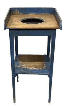 M1123 19th century Mid-Atlantic Washstand bearing its original blue painted surface.  Stand features an applied gallery with opening for the basin and shelf below, and rests on tall, very delicate tapered legs that are mortised and wooden pegged into the apron. The wood is pine with square head nail construction. Circa 1840s-1850s.  Measurements: 18 &frac14;� wide x 17 5/8� deep x 35 &frac14;� tall (back) x 33� tall (front).