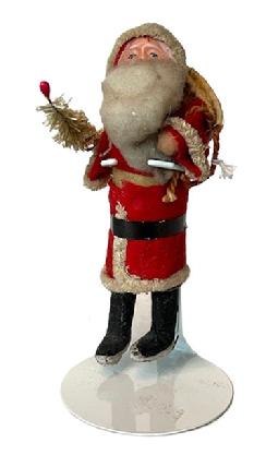 **SOLD** K1883 Santa holding small feather tree and a linen sack on his back and a tiny bell on the tip of his hat. He is on a metal stand for display purposes. Santa is approximately 5 1/2" tall.  