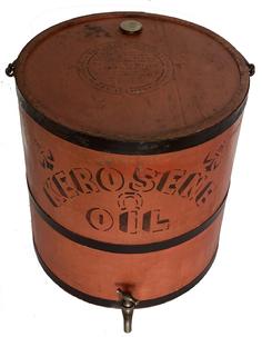 G453 Late 19th century large Kerosene Bucket in the original bittersweet red paint  with black lettern, It carries two patent dates on the top, the later of which is 1880. The container was made by Impervious Package Company of Keene NH, . There is a screw lid on the top for filling the can and a spigot for dispensing the oil or kerosene. There is another stencil on the side warning that water should not be placed in the container. The container holds five gallons.. It measures 11 7/8" in diameter at the top, 13 5/8" in diameter at the bottom and 12 7/*" tall.