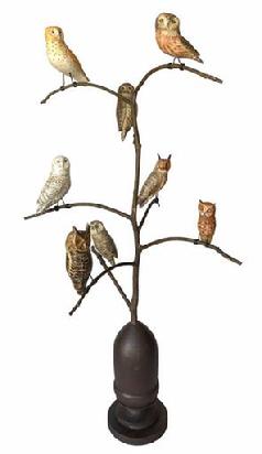 G897 Folk art owl bird tree carved by Ken Kirby featuring eight hand-carved wooden Owls with metal legs mounted on a tree that is anchored on a folk painted, acorn turned base.  Each Owl measures roughly 2 1/2� long and the tree stands 30� tall with base.