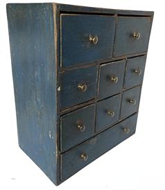 **SOLD** H1061 Spectacular 18th century Pennsylvania nine-drawer apothecary / spice chest with beautiful original blue painted surface. Dovetailed case and drawers with rose head nail construction elsewhere. Very unusual configuration of drawers with a layout consisting of 2 over 6 over 1 � all retaining their original brass knobs. The wood is pine. Circa 1750s. Measurements: 15 ½� wide x 8 ¾� deep x 18 ¼� tall