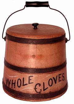 **SOLD** B446 19th century Bucket with the original salmon paint, with the words �Whole Cloves� in black paint with mustard decoration.  Staved construction secured with metal bands and original wire bale swing handle with wooden grip.  Measurements: 11� diameter (bottom) x 9 ¼� diameter (top opening) x 10� tall (not including knob on lid)  