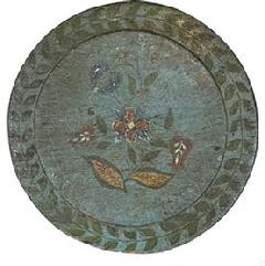 RM1476 Beautiful mid-19th century original blue painted and decorated cutting board bearing a Pennsylvania Dutch-style hand painted floral motif on the slightly raised center, encircled by a garland of hand painted leaves on one side and natural patina with extensive wear from years of use on the opposite side.  Measurements: 11� diameter x ¾� thick (in center) 