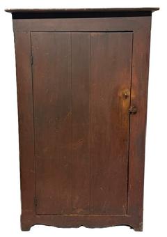 M1138 Mid-19th century Eastern Shore, Maryland original red painted one door storage cupboard resting on cut out front feet and half-moon cut out ends. The clean interior bears the same original red painted surface as exterior. Front corners of the cupboard are rounded, and the top board is also rounded to match. The wood is pine with square head nail construction. Circa 1860s. The top measures 41 &frac34;� wide x 14 &frac34;� deep. Case measures 38 &frac14;� wide x 12 &frac34;� deep. Overall height is 67 &frac14;� tall.  