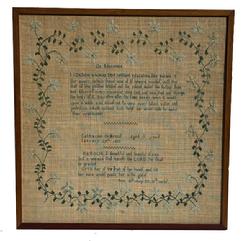 M308 Exceptional early 19th century identified and dated, hand-stitched sampler by �Catharine O Hevius   Aged 11 years   January 29th 1828�.  Sampler is stitched with what appears to be cotton threads over linen material and boasts blues, green, brown, and ecru colors.  Features a central verse entitled �On Education� above her identification and the full Bible verse of �Prov. 31st chap 30. 31st verses� below. This fantastic work is surrounded by an intricate vine and flowers along all four edges. Appears to have been professionally mounted and framed as a sticker from �L. Bamberger & Co � Newark, NJ� remains intact on the back. Wire on back for hanging purposes. Framed measurements are 17 &frac34;� wide x 18 &frac14;� tall x 3/8" thick.