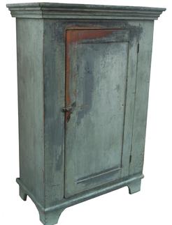 W364 Mid 19th century single door Milk Cupboard, with wonderful old pewter over the original slate gray paint. Applied three step molding on top, with a single panel door,nice high cut out base, three board back, circa 1840 - 1850  Measurements are: 40 1/2" wide x 20 3/4" deep 59 3/4" tall