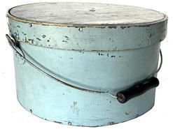 J413 19th century Pennsylvania bail handle Pantry Box with lid. Light blue painted surface over the original darker blue paint. Steamed and over lapping bentwood sides are secured with small metal tacks. The sides of the pantry box are fitted with a pair of metal handle mounts securing an arched wire swing handle with wooden hand grip. Heavy construction with tightly fitting lid. Measurements: 11 ¾ diameter (top) x 11 ½ diameter (bottom) x 6 ¼ tall