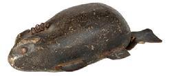 L505 Hand carved wooden Beaver fishing decoy with leather tail, imbedded metal weights, tin legs and tack eyes. Original painted surface. Approximate measurements: ~8" long x ~3 5/8 wide x ~2 ½ tall.