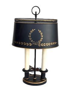 L525 Early 1900s Tin Bouillotte (pronounced �BOO-lot�) Twin Desk Lamp. The wonderful tole painted surface consists of tiny leaves stenciled in gold on a black background. Great condition with original finial. Base measures 7� wide x 7 &frac14;� deep. Overall height is 19 &frac12;� tall. 