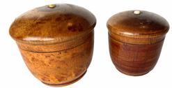 372 Pair of treenware spice / trinket boxes attributed to the Lancaster-Lebanon County region of Pennsylvania. Both turned wood boxes have tightly seated, slightly domed lids with tiny porcelain knob buttons, red sponge paint accents and are in overall good condition with dark patina and wear from use. Both boxes have a narrow rim foot. (NOTE: The lid on larger box is cracked/glued.)