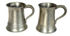 L269A Pair of Pewter mugs – each is marked “½ Pint”. One has the initials "M.b." engraved on the bottom. Each measures approximately 3 3/8” bottom diameter x 3” top diameter x 4” tall.