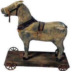 **SOLD** G533 Wooden Painted Horse Pull Toy on Wheels from the mid 1800s. There are still traces of the original saddle and harness . Original paint is worn, but there are traces of the old dapple-grey