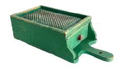RM1630 Early wooden box grater with drawer retaining its original dry green painted surface. Grater boasts a hand punched perforated, heavy metal grater surface over a sturdy full length functional drawer that slides in and out without problems and has a small knob for easy opening/closing. A cut-out handle  with hole for hanging purposes and shaped ends by the drawer opening add to the visual appeal to this functional kitchen necessity. Maker attached a 5/8� wide strip of wood across the back to slightly elevate the upper end of the grater when in use. Great wear indicative of age and use. The wood is pine � with small wire nail construction. Circa 1880s � 1900. Measurements:15 5/8� long x7 1/8� wide x 4� tall.