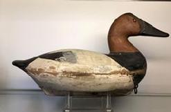 E299 Canvasback decoy carved by John (�Jack�) McKenney (1889-1973) from Chestertown, MD. Brand on the bottom reads: �E. A. VOSHELL� who was Mr. McKenney�s father-in-law. Bill Shauber, another carver from Chetertown, MD, states Mr. McKenney was his Uncle and that he only carved approximately 500 birds in his lifetime, mostly during the 1950s. This decoy retains both its wooden keel (with lead lining the bottom outer portion of the keel)