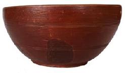 H97   Wonderful New England wooden bowl, hand turned bowl is out of round, footed, in the original red painted surface with strong evidence of slow lathe turning, and resting on raised foot. This Bowl is deep rather than the more typical shallower bowls.  