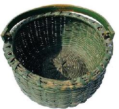G515 Late 19th century finely handwoven basket from New England in a Shaker style, with the original green paint. The basket has the original kick up bottom and the original hand carved handle.