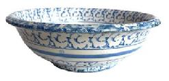 L334 19th century blue and white Spongeware bowl featuring the classic sponge-applied blue speckled pattern with two solid white and a solid blue band in center. Interior also boasts blue and white decoration. Tapered lipped rim and raised footed bottom. Measurements: 14 5/8 top diameter x 7 ¼ bottom diameter x 5 tall.