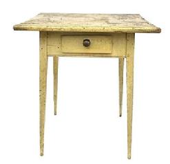 M149 Lancaster County, Pennsylvania Hepplewhite splay leg one drawer table with original mustard yellow painted surface resting on tall, very gracefully tapered splay legs. Mortised and wooden pegged construction with deeply carved beaded edge along the bottom edge of the apron on all sides. The drawer is square head nail construction with original brass knob. The wood is pine. Circa 1820s. One-board top. Measurements: 25 wide x 22 ½ deep x 27 ¾ tall.