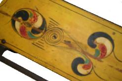 W59 ANTIQUE PAINT DECORATED CHILDS SLED. red and blue, yellow paint decorated top, Wrought iron runners. some wear to the paint