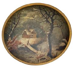 L119 19th century hand polychrome painted wooden bowl with a winter landscape scene of house by a stream in the snow with a bundled-up person standing on a wooden bridge in the forefront. Unsigned. The bowl is in good condition with no cracks or breaks. Slightly out of round. Measurements: 14 x 13 ½ diameter x 3 ¼ tall.