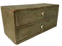 F130 19th century set of two drawers, all original in old green paint with the original knobs on the drawers. The case is nail construction with square head nails. Measurements: 16" wide x 7 ½ deep x 7 ½ tall