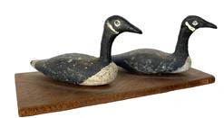 G682 Two hand carved and painted miniature wooden goose decoys mounted on a thin piece of wood. All original. Label on bottom identified to: Edward G. Dietert  Easton, MD. Each goose measures 3 3/4� long x 1 1/4� wide. Overall mounted measurements: 6� long x 2 3/4� wide x 2 1/4 tall. 