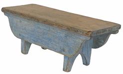 G893 Wonderful Pennsylvania original blue painted wooden stool with wide, double sided, curved-end aprons that drop a full 3½� below the top on each side. Pine wood, square nail construction with boot jack cut out feet. Circa 1850's.  Measurements: 6 1/4" wide x 6 1/2" deep x 6 1/4" tall