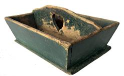 H292 Mid-19th century Pennsylvania original green painted cutlery tray with heart cut out handle. Canted sides and molded edges around base. Square head nail construction. Great wear and patina. Circa 1850. Measurements: 13 34" long x 11" wide x 5 3/4" tall in center of handle.
