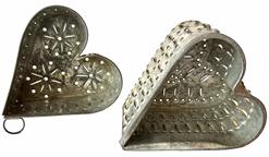 H452 Two fantastic Pennsylvania antique pierced tin heart shaped footed cheese molds. High quality with rolled and molded edges, decorative punched/pierced designs and very distinct raised feet. Circa 1800�s. Excellent condition. One measures 4� wide x 4 3/4� tall x 4� deep and the other measures 4 3/8� wide x 4 1/2� tall x 3� deep.