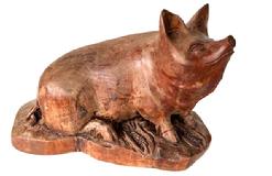 K1842 Hand Carved Wood Pig Sculpture signed by maker  C. Logue. Solid wood with exceptional carved details, including a curled tail, pointed ears, wrinkled upturned nose and characteristic eyes as well as cobs of corn around the pigs front feet. Heavy, solid wood earing original natural surface. Approximate measurements: 11 ¼ long x 6 ½ wide x ~ 7 tall.   